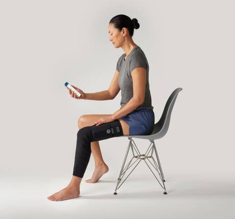 User-provided photo of a seated woman wearing Cionic Neural Sleeve